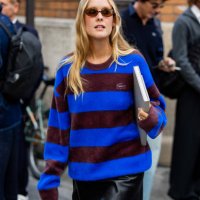Guest wears blue burgundy striped sweater outside Lacoste during Womenswear Spring/Summer 2025 as part of Paris Fashion Week on October 01, 2024 in...