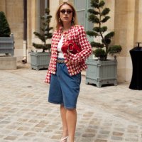 Guest wears blue denim Bermuda shorts, a white top, a red and white checkered jacket, and a red Gucci bag outside Peet Dullaert during the Haute...