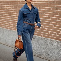 Guest wears blue jeans, a blue denim shirt, and a brown leather bag outside Fendi during the Milan Fashion Week - Womenswear Fall/Winter 2024-2025 on...