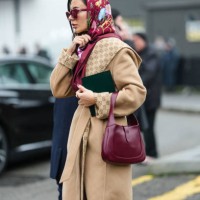Guest wears burgundy bordeaux Gucci sunglasses, burgundy bordeaux floral pattern Gucci scarf, a gold ring, light brown Gucci monogram Gucci belted...