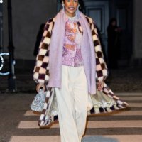 Guest wears checkered coat, lavender scarf, white pants outside Stine Goya during the Copenhagen Fashion Week AW24 on January 31, 2024 in Copenhagen,...