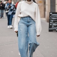 Guest wears cream sweater and baggy jeans, outside Dries Van Noten, during the Womenswear Fall/Winter 2024/2025 as part of Paris Fashion Week on...
