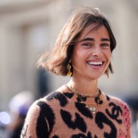 Guest wears dark brown black leopard pattern/print red floral pattern/print sweater, outside Chanel, during the Paris Fashion Week Spring/Summer 2025...