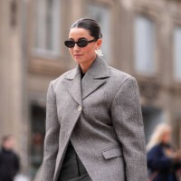 Guest wears earrings, sunglasses, a gray oversized blazer jacket , outside The Garment, during the Copenhagen Fashion Week AW24 on January 31, 2024...