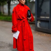 Guest wears gold earrings, bright red turtleneck long sleeve Ferragamo, bright red suede Ferragamo trench coat, bright red tight Ferragamo pants,...