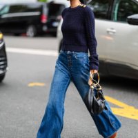 Guest wears gold earrings, navy blue knit sweater with gold detail, navy blue denim jean cutout pants, dark brown Chloe platform shoes, shiny black...