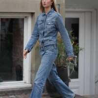 Guest wears gold with white pearl pendant earrings, a blue denim jacket, matching blue denim wide legs pants, white leather / gray suede / black logo...