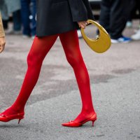 Guest wears golden Coperni bag, red tights outside Philosophy during the Milan Fashion Week - Womenswear Spring/Summer 2024 on September 22, 2023 in...
