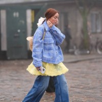 Guest wears golden earrings, a yellow floral embroidery mini mesh dress, a blue checkered / checked pattern printed jacket, a bag, pink shoes,...