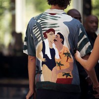 Guest wears graphic shirt and black pants outside Ardazaei show during the Haute Couture Fall/Winter 2025/2026 as part of Paris Fashion Week on July...