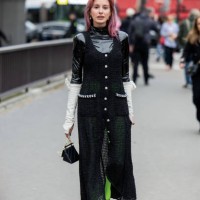 Guest wears green black button up transparent dress, neon green tights, black bag outside Chanel during the Womenswear Fall/Winter 2024/2025 as part...