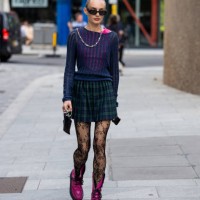 Guest wears green checkered skirt outside David Koma during London Fashion Week September 2023 at the on September 16, 2023 in London, England.