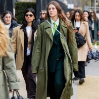 Guest wears green coat outside Lacoste during the Womenswear Fall/Winter 2024/2025 as part of Paris Fashion Week on March 05, 2024 in Paris, France.