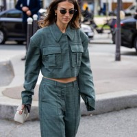 Guest wears green jacket with side pockets, pants outside Stella McCartney during Womenswear Spring/Summer 2025 as part of Paris Fashion Week on...