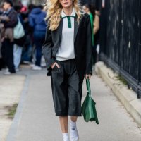 Guest wears green shorts, blazer, bag outside Lacoste during the Womenswear Fall/Winter 2025/2026 as part of Paris Fashion Week on March 09, 2025 in...