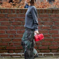 Guest wears grey knit, red Jacquemus bag, camouflage pants with side pockets outside Nicklas Skovgaard during the Copenhagen Fashion Week AW24 on...