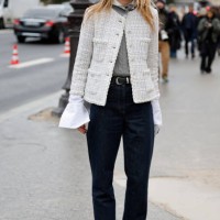 Guest wears grey sweater, dark blue jeans, cream tweed jacket, outside Chanel, during Haute Couture Spring-Summer 2025 as part of Paris Fashion Week...