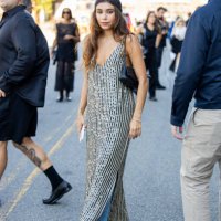 Guest wears head pice, striped dress, denim jeans, heels, bag outside Cos during New York Fashion Week on September 10, 2024 in New York City.