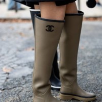Guest wears khaki gumboots outside Chanel during the Womenswear Spring/Summer 2024 as part of Paris Fashion Week on October 03, 2023 in Paris, France.
