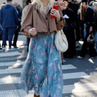 Guest wears light blue floral print maxi dress, beige Chloé bag, brown crop jacket, brown wedge shoes, outside Chloé, during the Womenswear...