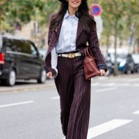 Guest wears light blue shirt, burgundy striped suit, blue hat, burgundy Hermes bag, outside Shiatzy Chen, during Womenswear Spring/Summer 2025 as...
