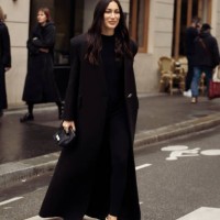 Guest wears long balck coat and black mini bag outside Chloe during the Womenswear Fall/Winter 2024/2025 as part of Paris Fashion Week on February...