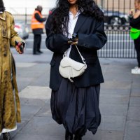 Guest wears oversized blazer, skirt, white Dior bag outside JW Anderson during London Fashion Week September 2024 on September 15, 2024 in London,...