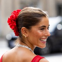 Guest wears red dress, necklace, red hair band outside Gestuz during day four of the Copenhagen Fashion Week SS25 on August 08, 2024 in Copenhagen,...
