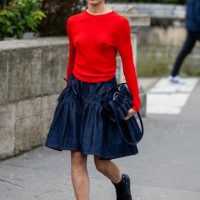 Guest wears red long shirt, dark denim skirt, bag outside Cecilie Bahnsen during the Womenswear Fall/Winter 2024/2025 as part of Paris Fashion Week...