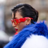 Guest wears red sunglasses from Casablanca, outside Casablanca, during the Womenswear Fall/Winter 2024/2025 as part of Paris Fashion Week on February...