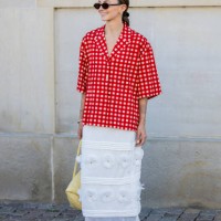 Guest wears red white checkered button shirt, white skirt outside Lovechild 1979 during day two of the Copenhagen Fashion Week SS25 on August 06,...