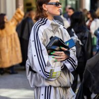 Guest wears silver Adidas track suit, black bagoutside Bora Aksu during London Fashion Week September 2024 on September 13, 2024 in London, England.