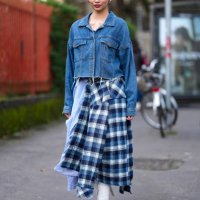 Guest wears silver earrings, navy blue cropped denim jean jacket, light blue white striped dark blue plaid pattern midi skirt, white pointed toe...