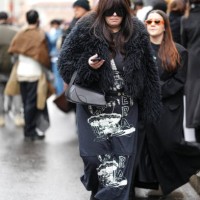 Guest wears sunglasses, a black fluffy faux fur coat, a long dress, outside Magliano, during the Milan Fashion Week Menswear Fall/Winter 2025-2026 on...