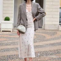 Guest wears twit gray jacket from Chanel and Luisa Beccaria floral dress during the Milan Fashion Week Menswear Spring/Summer 2025 on September 18,...