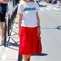 Guest wears white Alitalia printed t-shirt, red bermuda, red bag, red socks, red sneakers, outside Craig Green, during the Menswear Spring/Summer...