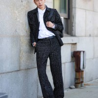 Guest wears white buttoned up long sleeve shirt, black gray pattern jacket, black gray pattern pants, black leather belt, silver rings, shiny black...