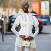 Guest wears white laced transparent dress, bagoutside Georges Hobeika during the Womenswear Fall/Winter 2025/2026 as part of Paris Fashion Week on...