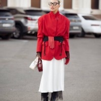 Guest wears white long skirt, red jacket, long black boots, white and red bags, black belt and one red glove during the 10th season of the Visa...