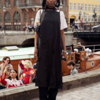 Guest wears white shirt and black dress at VIP guest trip with a boat to the Marimekko show during day four of the Copenhagen Fashion Week SS25 on...