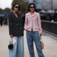 Guests are seen outside Chanel show wearing black Chanel sunnies, rose tweed Chanel jacket, black and white checkered tweed Chanel blazer, oversized...