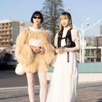 Guests are seen wearing a beige feather jacket and skirt, white boots and bag; a white dress with black vest during the Rakuten Fashion Week TOKYO...