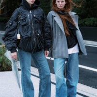 Guests are seen wearing a black hoodie, black bomber jacket, jeans, black boots; grey coat, jeans, grey sneakers during Rakuten Tokyo Fashion Week...