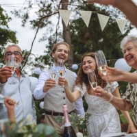 guests at the table are standing and clinking with champagne glasses. - garden decoration stock pictures, royalty-free photos & images