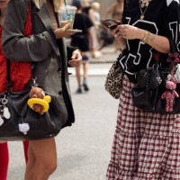 Guests holds black leather bags with accessories outside the Gestuz show during day four of the Copenhagen Fashion Week SS25 on August 08, 2024 in...