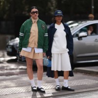Guests seen wearing a green college jacket, brow blouse with white details, matching skirt, white socks and black leather shoes and shades and a...