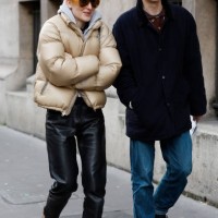 Guests wear beige bomber jacket, black leather pants, brown fur shoes, orange sunglasses , and blue jacket, blue jeans, black shoes , outside Issey...