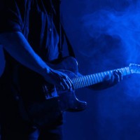 guitar advertising banner. male guitarist plays music in neon light with smoke. - concert stock pictures, royalty-free photos & images