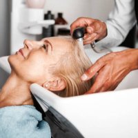 hair stylist washing mature woman hair - hairstyle stock pictures, royalty-free photos & images