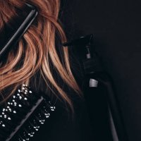 hairbrush and hair comb in long hair near styling foam. - hairstyle stockfoto's en -beelden